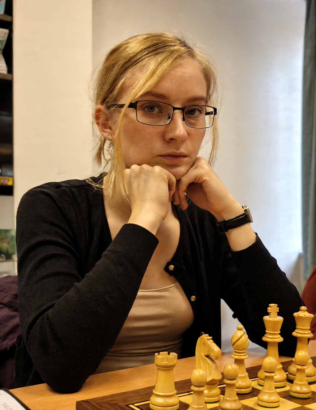 AI portrait of a woman with glasses resting her chin beside a chessboard in a cafe