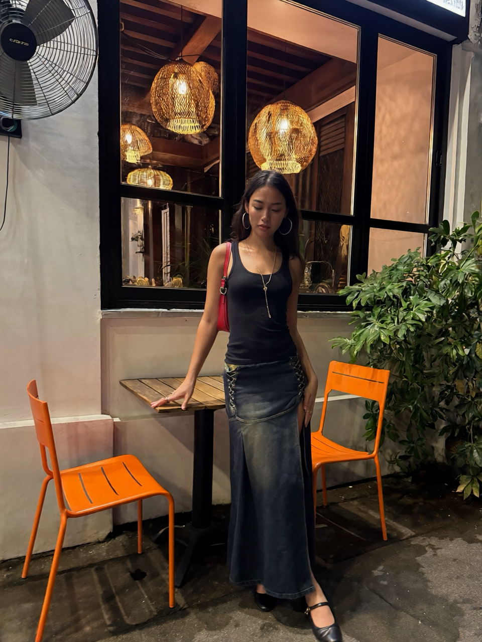 Full-length AI portrait of a woman in a dark outfit inside a warmly lit restaurant
