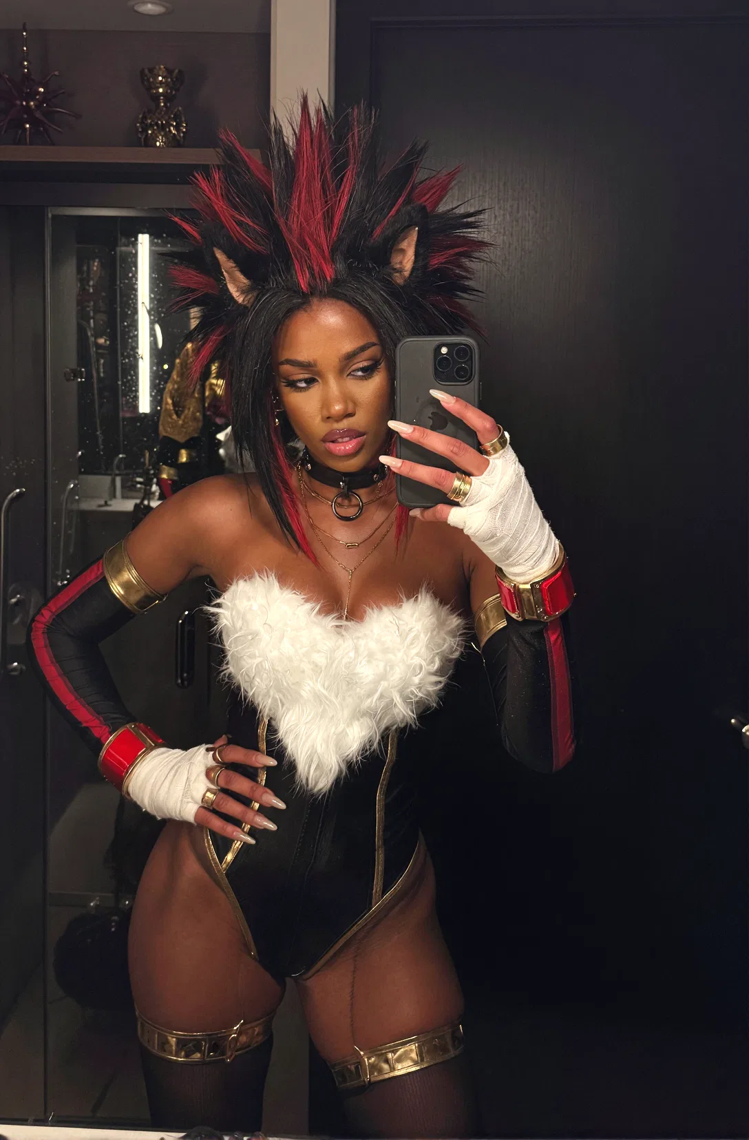 Girl taking a mirror selfie in a dark room wearing a black outfit with white feather trim, red accents, white gloves, thigh-high stockings,金